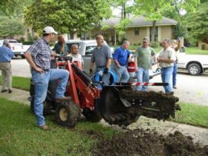 The Woodbridge Irrigation Repair Team trenches a new line