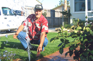 a Woodbridge Sprinkler Repair tech checks the pressure at the end of sprinkler line